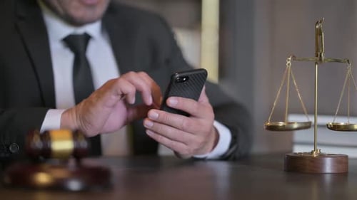 Close up of Judge Using Smartphone in Court
