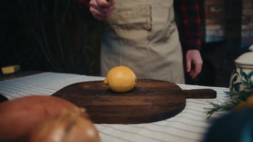Lemon Cutting Preparation with Knife on Wooden Board