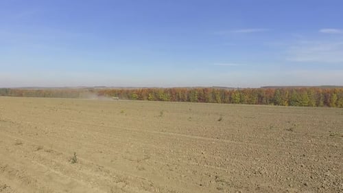 Big red combine working on the field cultivating and applying nitrogen ASP