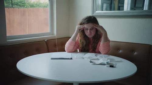 Worried Woman Reviews Finances at Home