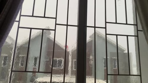 Water Droplets on a Pane of Glass with Blurred Home Background. Close up of Raindrops on a Window