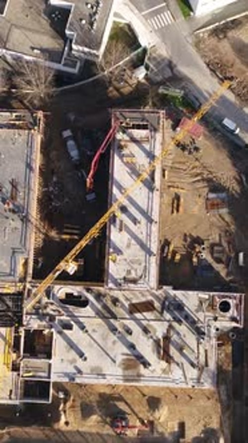 Vertical Video of Construction Workers in the Roof of New Building
