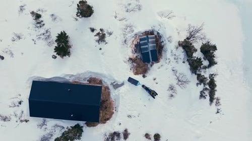 Above View Of A Cabin Surrounded By Snow In Winter Mountains. Aerial Topdown Shot