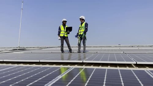 Technician installing solar cell. Installation and maintenance of solar cells on rooftop.