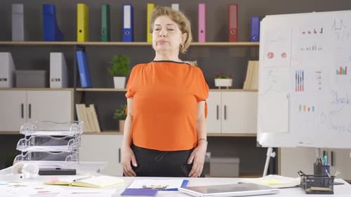 Woman Stretching Shoulders at Office Desk