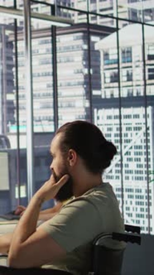 Man in Wheelchair Works in Modern Office