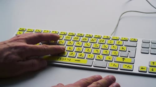 Blind Person Reading Some Braille Text on Keyboard Palms Moving Tactile Keys Creating Text