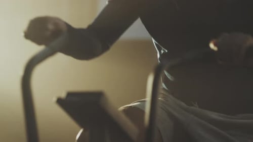 Man riding stationary bike at gym