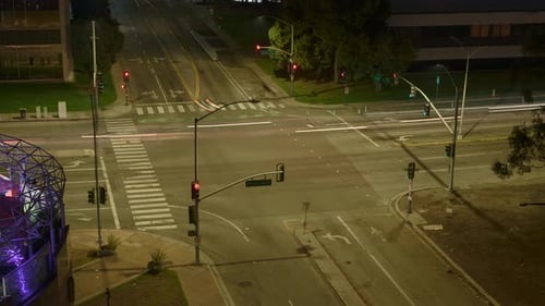 Nighttime timelapse of traffic at a busy Long Beach intersection with light trails