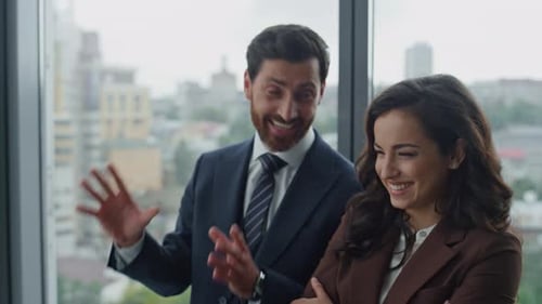 Two Smiling Colleagues Talking in Office Corridor at Work Break Close Up