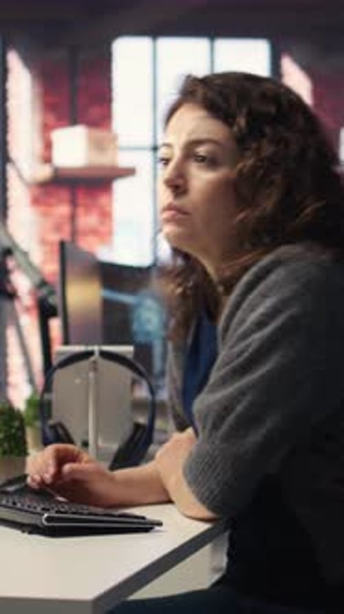 Woman Working at Computer in Urban Office