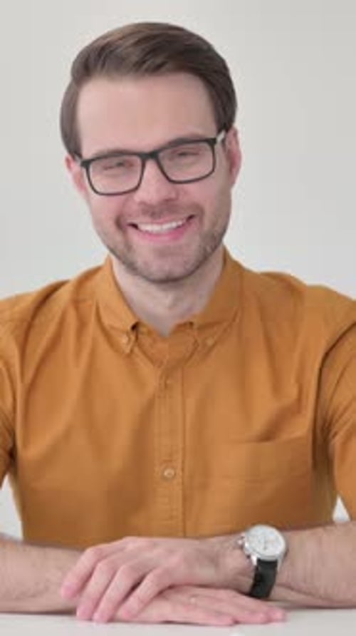 Man with Glasses Smiling at the Camera