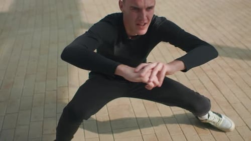 Precise Side Lunges in City Surroundings Executing Controlled Side Lunges on Tiled Surface Within