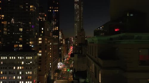 Camera Pans Over Illuminated Streets and Skyscrapers of Midtown Manhattan New York City Showcasing