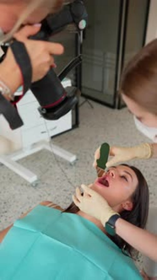 Female Dentist Taking Photo Result Dental Treatment in Dental Clinic