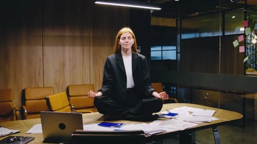 In Her Stylish Office a Businesswoman Meditates to Find Inner Peace Amid Corporate Challenges