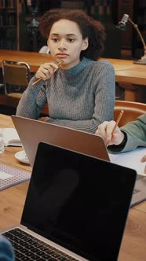 Diverse Mixed Race Students Prepare for Examination Together at Library