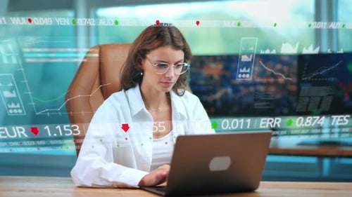 Business Woman working concentrated on laptop in modern office with digital graphs stock market fina