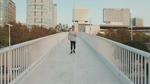 Young man in wireless headphones on a morning run