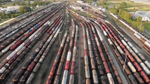 Aerial dolly shot Showing Large Train Depot With Many colorful cargo Trains