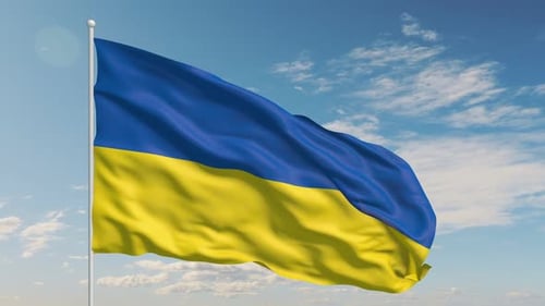 Waving Ukraine Flag Against Clear Blue Sky