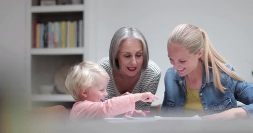 Grandmother, Mother, and Child Drawing at Table