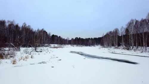A Beautiful Winter Landscape Featuring a Frozen River and SnowCovered Trees in Nature Stock Clip