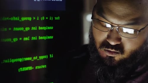 Close Up Computer Code Over Focused Male Hacker in Office 3539 Years