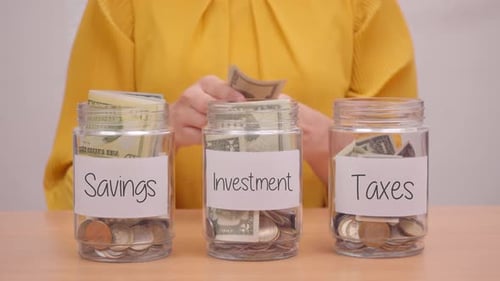 Woman Allocates Money to Savings Investment and Taxes