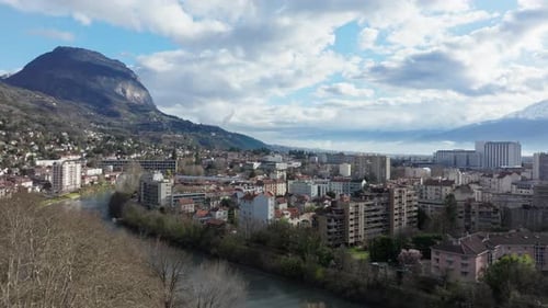 Aerial View of Grenoble City Center Showcasing the Isere River Winding Through Buildings and the