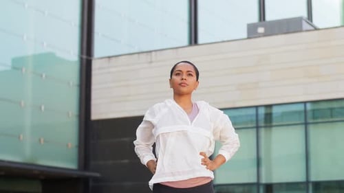 Woman Stretching Arms Outdoors in Urban Setting
