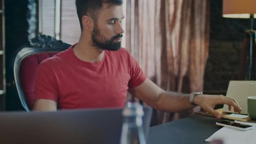 Business Man Working On Laptop And Chatting On Phone In Office. Beard Man Smiling While Typing Mo...