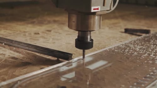 Close up shot of a laser cutting machine carving patterns on the plastic plate. Production of goods