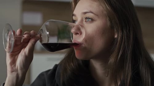 Woman Drinking Red Wine Close Up Indoors