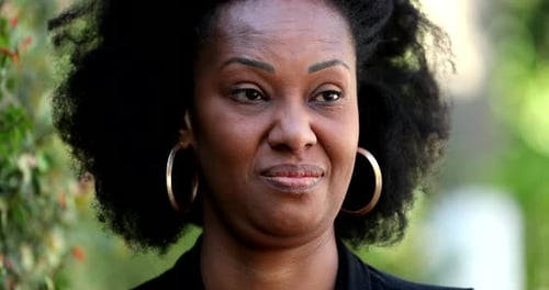 Skeptic black woman judging with disgust, close-up face emotion
