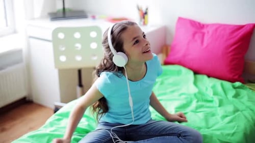 Energetic Girl Listening to Music on Headphones Dancing