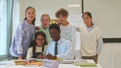 Teacher with Happy Young Students in Classroom