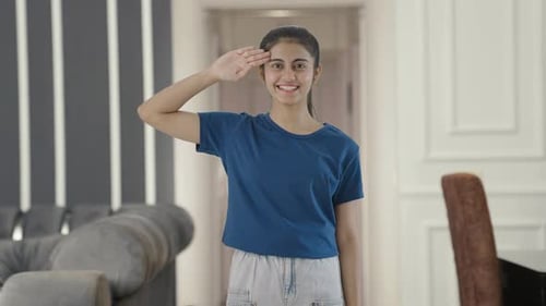 Proud Indian teenage girl saluting