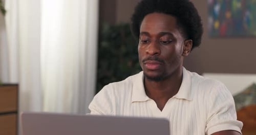 A Student Uses a Laptop to Write a Project for College Young Man Studies Online Virtual School