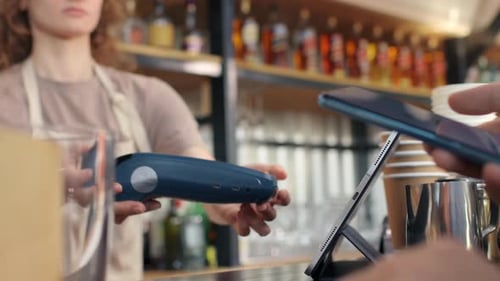 Paying with smartphone at coffee bar pos terminal modern lifestyle