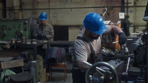 Men Working with Machinery in Shop