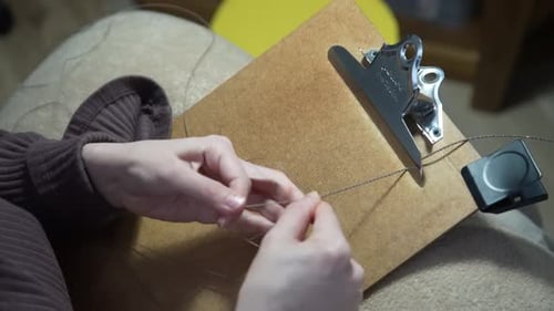 Threading String Through a Needle Close Up