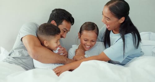 Joyful Family Giggles Together in Bed