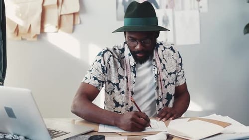 Fashion Designer Creates Sketches in Bright Studio