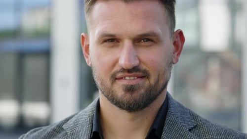 Close Up Portrait of Handsome Caucasian Businessman Standing Smiling Looking at Camera Outside Near