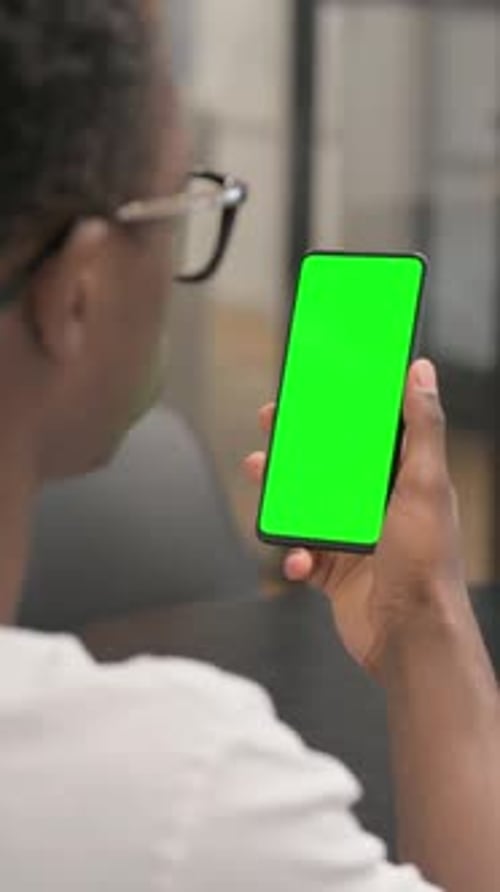 Close up of African Man using Phone with Green Screen