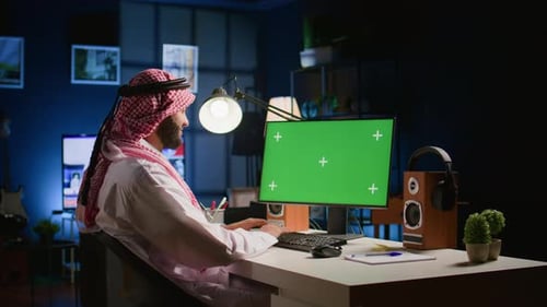 Man Working at Computer with Green Screen