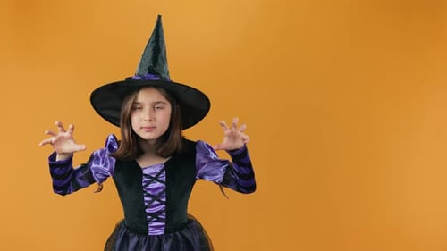 Spooky Sorceress Conjuring Spells then Laughing on Orange Backdrop
