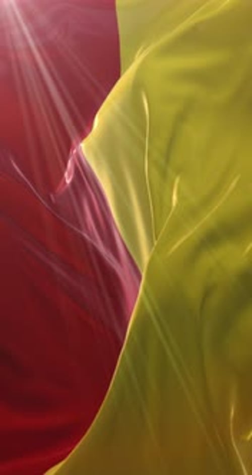 Flowing Red and Yellow Fabric Background with Light Rays
