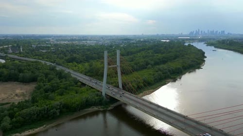 Aerial panning shot of traffic on Siekierkowski bridge with skyline of Warsaw in background. Panoram